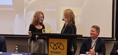 Acting CEO Justine Heath presents Professor Bentley with her award