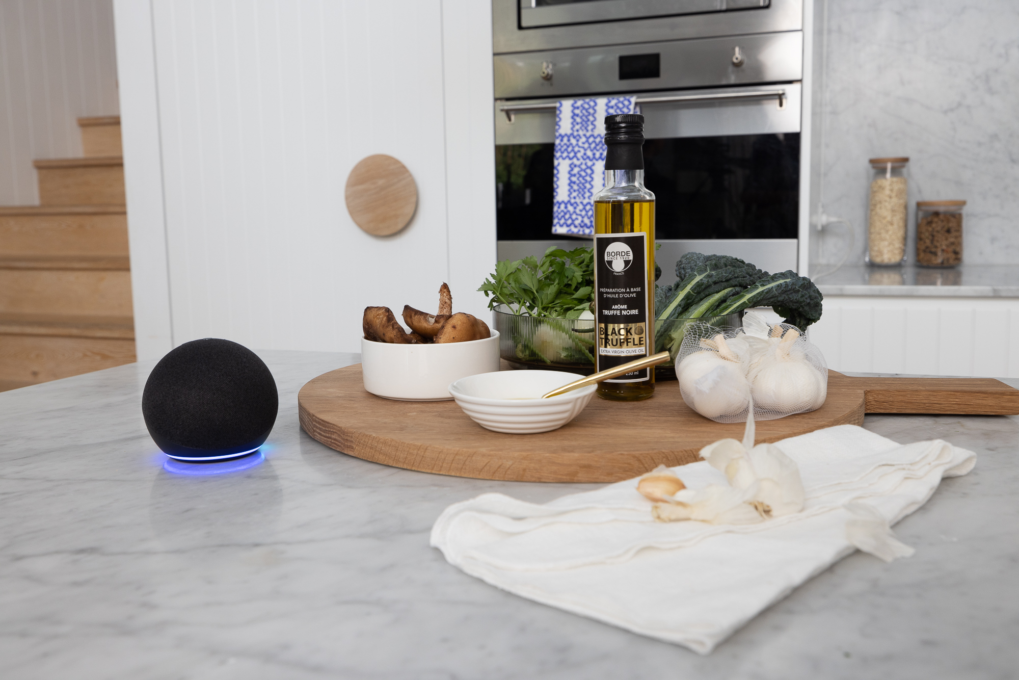 An Amazon device on a bench next to ingredients