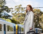 Kate Begley, a young woman stands on the train platform