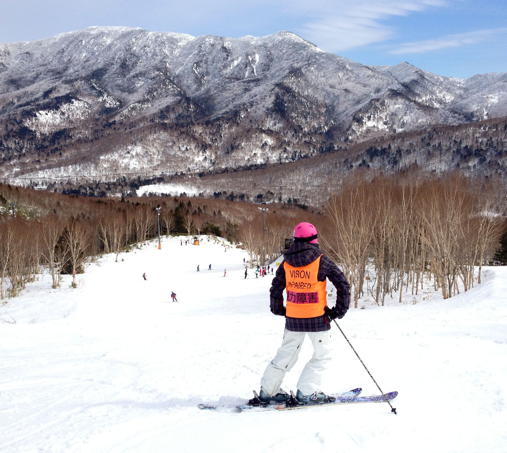 Debbie stands at the top of a ski slope