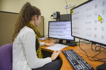 Image shows VA client Caroline using a computer with screen magnification software