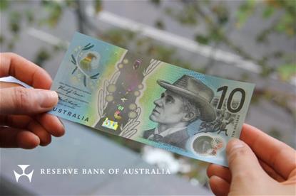 Two hands holding the new $10 note