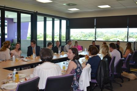 Members of the CRG and Board seated around a table.