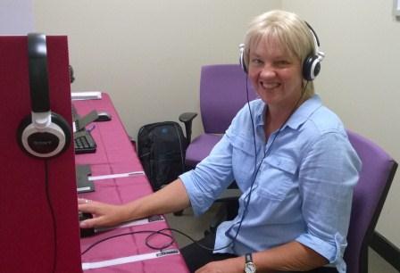 Vision Australia client Susan McAlister sitting infront of computer, preparing to vote with e-Assist