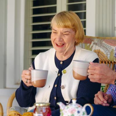 A woman enjoying a cup of tea.