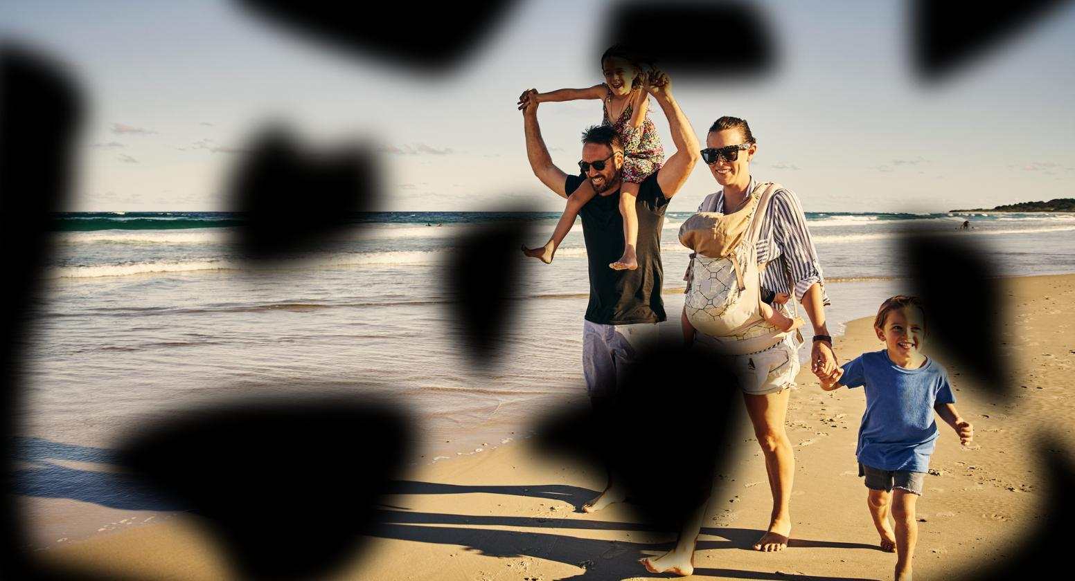 Diabetic retinopathy: Image of a happy family walking on the beach with dark blurred spots across various parts of the image. Diabetic retinopathy: Image of a happy family walking on the beach with dark blurred spots across various parts of the image.