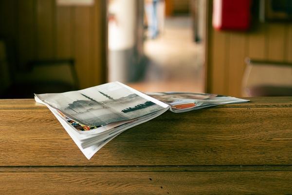 A magazine laying open on a wooden table